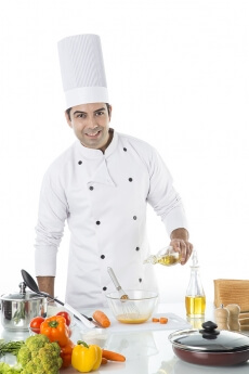 chef adding oil to the bowl 