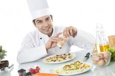chef adding ingredient 