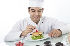 chef adding cherry on the burger