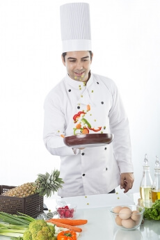 chef in kitchen making dish