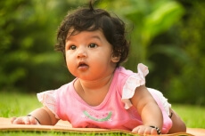 cute little girl lying on park