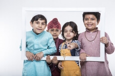 kids from different religions posing from a frame 