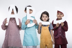 kids peeking through alphabets