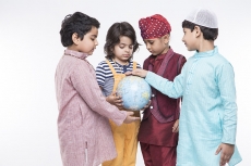 four kids carrying globe while posing
