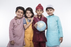 four kids carrying globe while posing