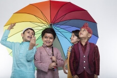four kids from different religion under one umbrella
