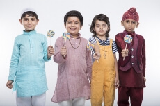 four kids posing with candy 