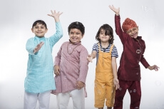 four kids from different religion playing with bubbles