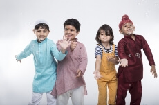 four kids from different religion playing with bubbles