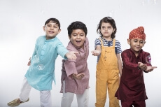 four kids from different religion playing with bubbles