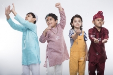 four kids from different religion playing with bubbles