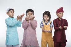 four kids from different religion playing with bubbles
