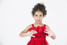 girl wearing red dress gesturing