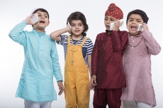 kids from different religions with mobile phones 
