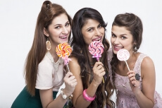 stylish girls eating candies 