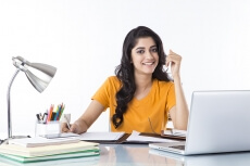 woman sitting and working on laptop 