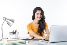 woman sitting and working on laptop 