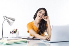 woman sitting and working on laptop 