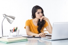 woman sitting and working on laptop 