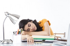girl sleeping at her study table 