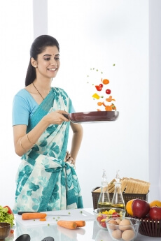 Indian housewife tossing up while cooking