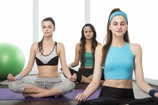 girls exercising in gym together 