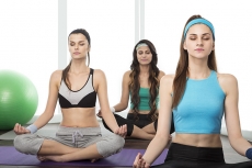 girls exercising in gym together 