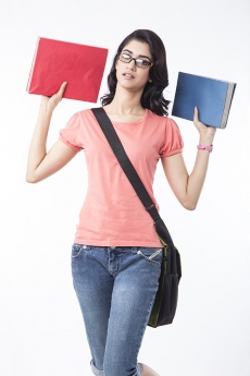 college girl posing with text books