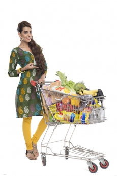 Indian woman posing with shopping kart