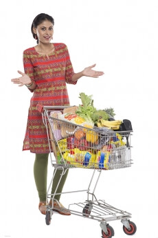 Indian woman posing with shopping kart