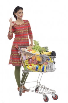 Indian woman posing with shopping kart