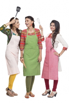 women wearing apron with kitchen utensils