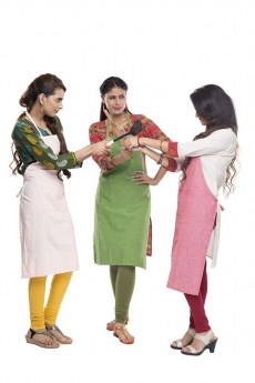 women wearing apron with kitchen utensils