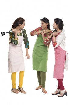women wearing apron with kitchen utensils