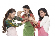 women wearing apron with kitchen utensils