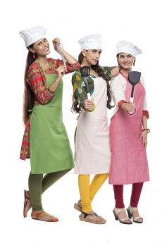 women wearing apron with kitchen utensils