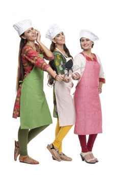 women wearing apron with kitchen utensils