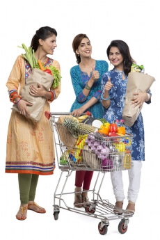 woman posing with shopping bags and shopping cart