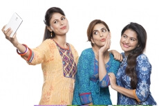 Three women taking selfie on phone