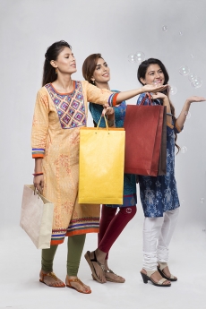 Three Indian women with shopping bags