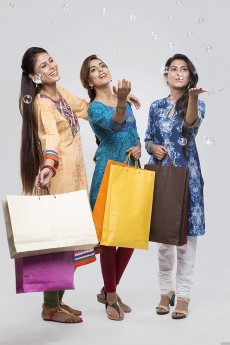 Three Indian women with shopping bags