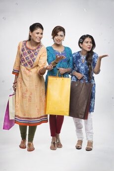 Three Indian women with shopping bags