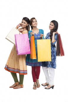 Three Indian women with shopping bags