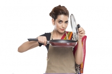 women wearing apron with fry pan
