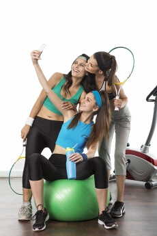 young girls taking selfie at gym