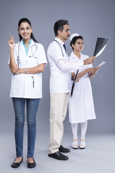 Doctor examining x ray report & medical staff