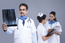 Doctors with x ray reports behind medical staff