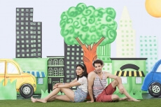 couple sitting back to back in garden