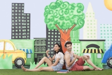 couple sitting back to back in garden eating candy