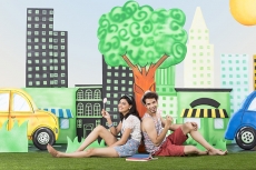 couple sitting back to back in garden